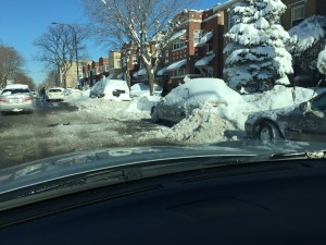 Cars covered in snow and neighbors pushing snow into the street, 2015. Snow blizzard
