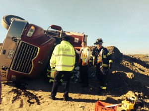 Orland Fire Protection District emergency responders work to extricate a driver pinned in the cabin of his overturned truck on La Grange Road in Orland Park Saturday Oct. 10, 2015