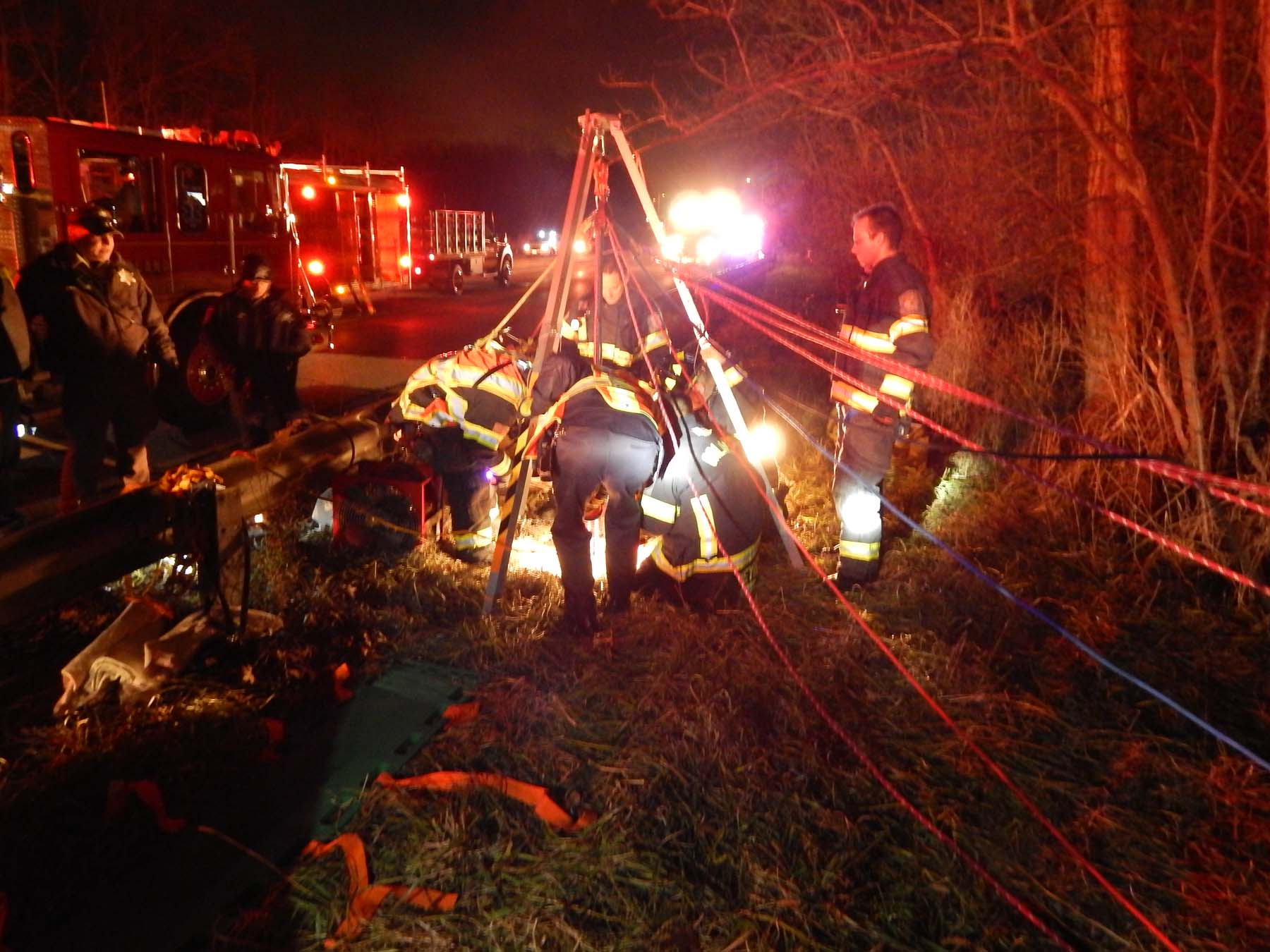 Orland Fire Protection District emergency rescue crews work to remove a man from a sewer pipe at about 145th and Harlem Avenue on Saturday night, Dec. 27, 2014. The man was walking along the forest preserve district returning to his car at 151st Street when he fell 20 feet down into the sewer pipe, using his phone to call 911