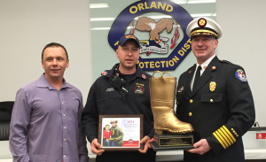 OFPD President Jim Hickey (left) joins Engineer Robert Griffin (center) and Fire Chief Ken Brucki in accepting the Golden Boot Award for raising a record $25,000 to fight Muscular Dystrophy. (Photo courtesy OFPD)