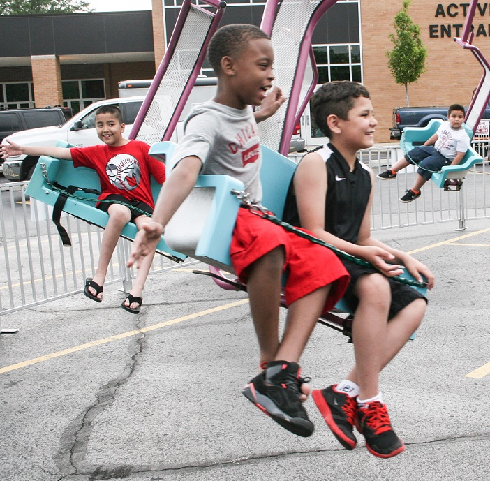 Flying Chairs: These kids having a thrill ride at Saturday's summer fest. Photos Copyright (C) Steve Neuhaus 2015. All Rights Reserved. Permission to reprint with full attribution to Steve Neuhaus and the Illinois News Network..