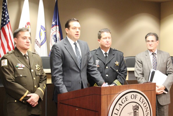 Lyons Mayor Christopher Getty (2nd from right) is joined by Cook COunty Sheriff's representative Michael Anton, Lyons Deputy Police Chief Matthew Buckley and attorney Burton S. Odelson
