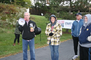 Orland Park Mayor Dan McLaughlin using a megaphone addressing the large turnout of supporters at today's Walk. Bridge Teen Center co-founder Priscilla Steinmetz also pictured alongside Mayor McLaughlin. Photos Copyright (C) 2015 Steve Neuhaus. All Rights Reserved